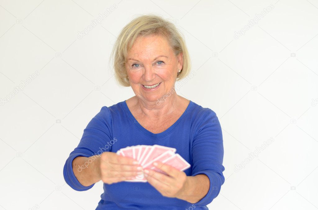 Smiling woman holding a hand of playing cards