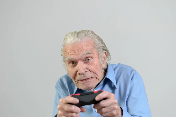 Funny grandfather playing a video game on console — Stock Photo, Image