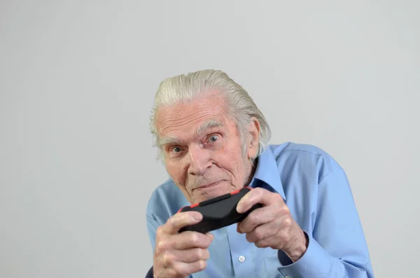 Funny grandfather playing a video game on console — Stock Photo, Image