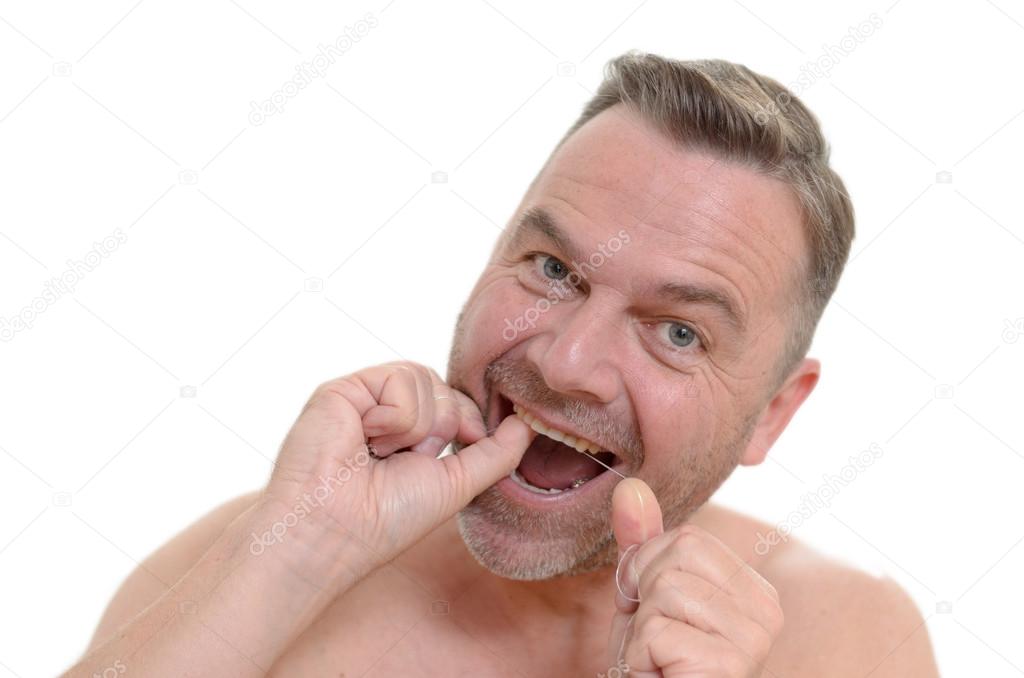 Man flossing his teeth with dental floss