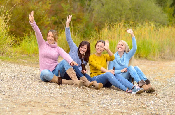 Group of happy young women waving at friends