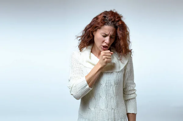 Attractive young woman coughing