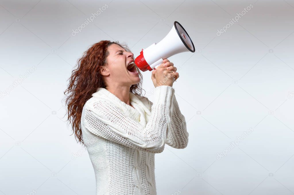 Young woman shouting into a megaphone