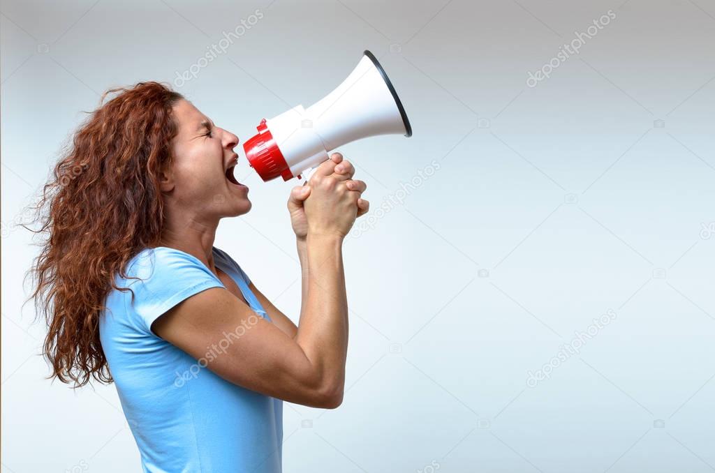 Young woman shouting into a megaphone