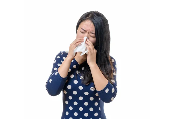 Unwell young Chinese woman blowing her nose — Stock Photo, Image