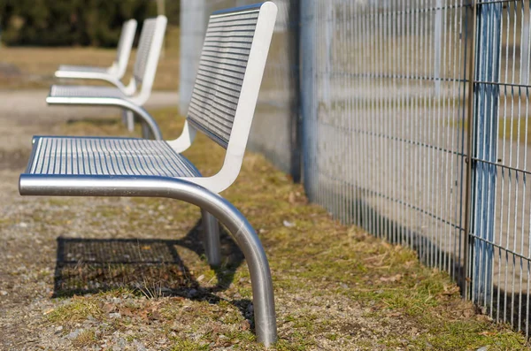 Modern metal benches in park