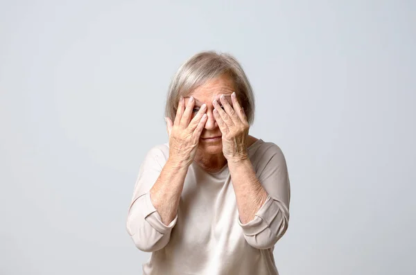 Woman covering eyes with her fingers — Stock Photo, Image