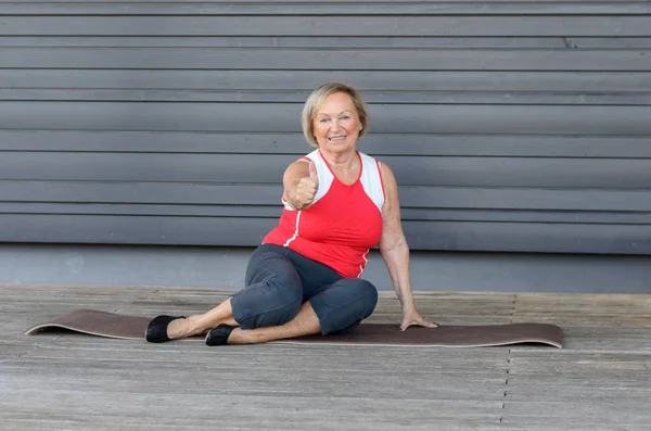 Senior woman giving a thumbs up after exercising — Stock Photo, Image