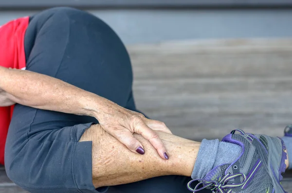 Senior woman suffering from leg cramps — Stock Photo, Image