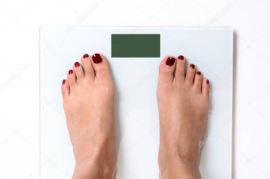 Woman feet on weight scales