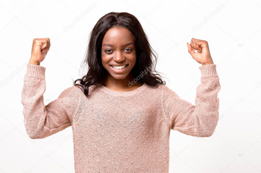 Exuberant young African woman cheering