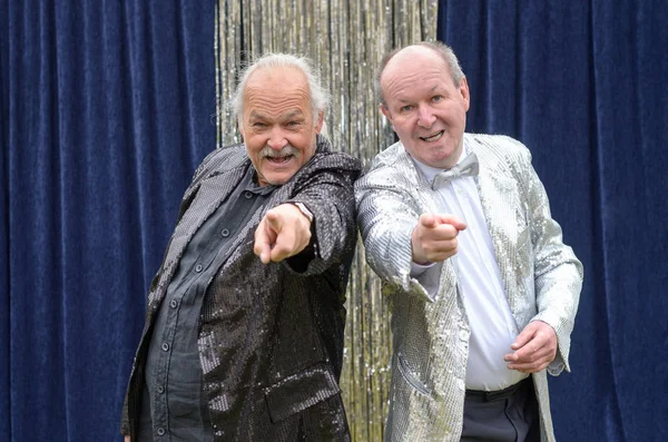 Two older men giving a lively stage performance — Stock Photo, Image