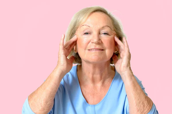 Senior woman showing her face, effect of aging — Stock Photo, Image