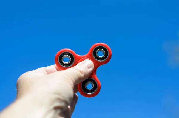 Man playing with a fidget spinner — Stock Photo, Image