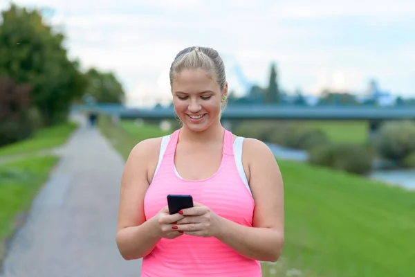 Young blonde woman using mobile phone outdoors — Stock Image Young blonde woman using mobile phone outdoors Stock Photo