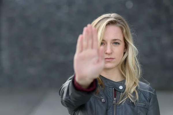 Stern young woman making a stop gesture — Φωτογραφία Αρχείου
