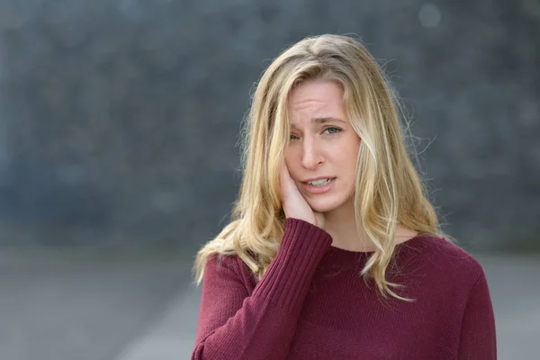 Sad young woman with a melancholy expression — Stock Photo, Image