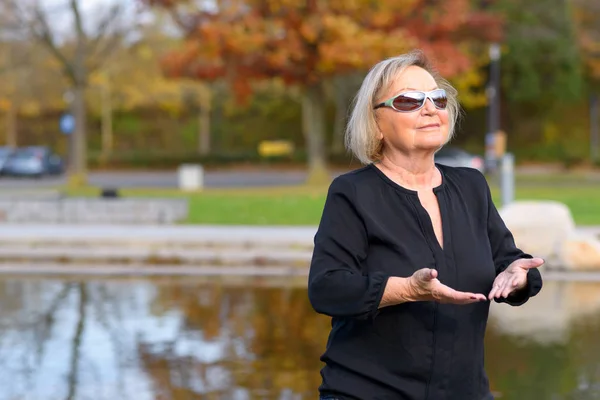 Relaxed senior woman enjoying a day in nature — Stock Photo, Image
