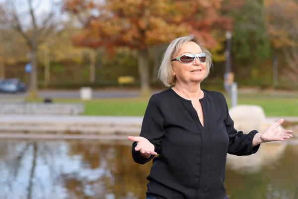 Happy relaxed senior woman celebrating the fall — Stock Photo, Image