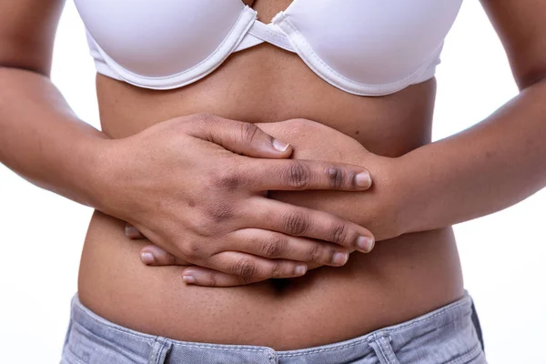 Mid section of woman holding her bare belly — Stock Photo, Image
