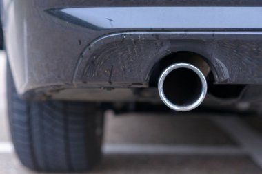 Low angle view of the exhaust pipe of a car clipart