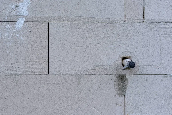 Cable on a cement brick wall — Stock Photo, Image