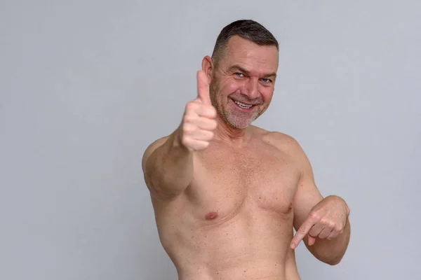 Retrato de hombre maduro desnudo dando pulgares hacia arriba — Foto de Stock