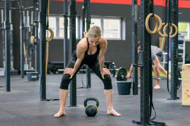 Güçlü bir spor salonunda bir mola verme kadın uygun