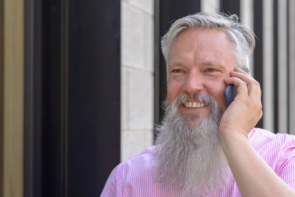 Attractive bearded man chatting on a mobile