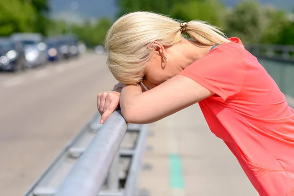 Mujer rubia apoyando su cabeza sobre sus brazos — Foto de Stock