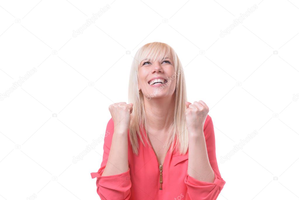 Jubilant woman cheering and clenching her fists