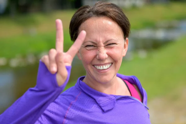 Cute Fun Loving Woman Giving Sign Beaming Smile She Takes — Stock Photo, Image