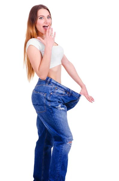 Junges Mädchen in blauen Jeans groß auf weißem Hintergrund — Stockfoto