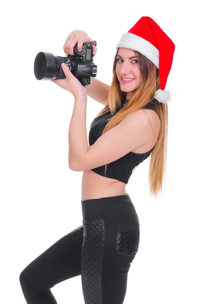 A rapariga do chapéu do Pai Natal com uma câmara. Jovem fotógrafa Natal. Selfie de Natal . — Fotografia de Stock