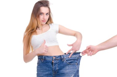  Diet. Fitness. Young Girl in blue jeans large size on a white background clipart