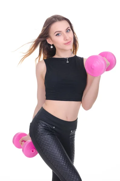 Diyet. Fitness. Genç güzel kız onun elinde pembe dumbbells ile. Kız spor egzersiz gerçekleştirir — Stok fotoğraf