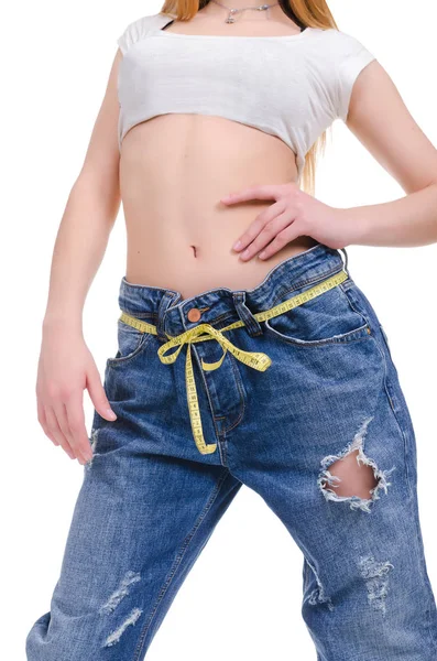 Diet. Fitness. Young Girl in blue jeans large size on a white background Stock Photo