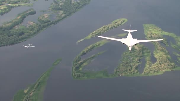 Two bombers fly of the river — Stock Video