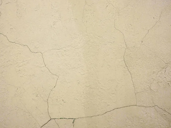 The old plastered background on a building wall with cracks — Stock Photo, Image