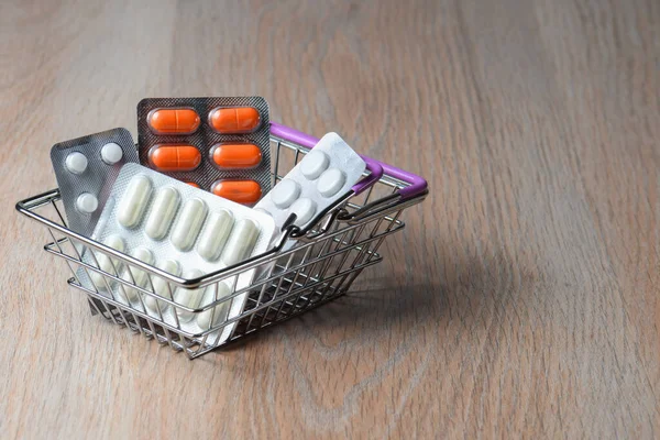 Package of medicine tablets in the shopping cart. Purchase of medicines pills. Protection from virus infection.