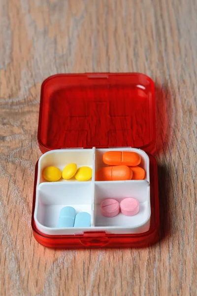 Tablets in a red pill box. Drugs for the treatment of coronavirus. A reminder of taking the pill.