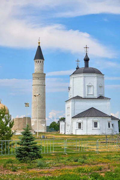 The minaret of the mosque and the Orthodox Church in the Bulgar historical and archaeological monument near Kazan.