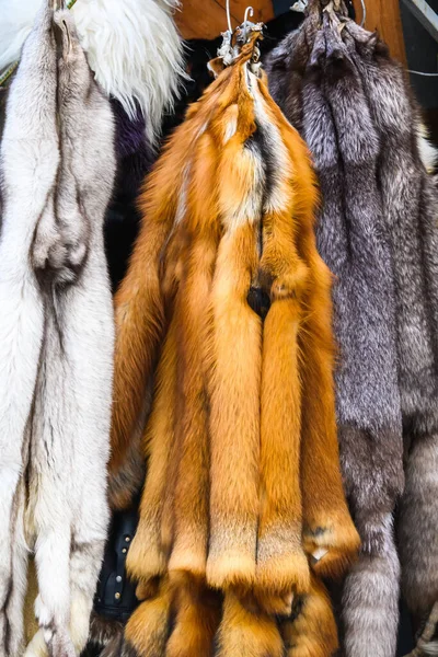Animal skins fur hung for sale. Merciless killing of animals. The social problem of killing animals for the sale of skins.