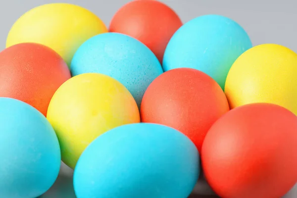 Colorful Easter eggs on a gray background. Easter eggs background. Easter eggs are a symbol and a mandatory attribute of the holiday.