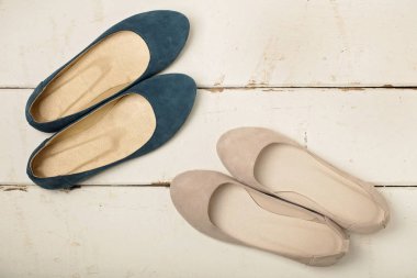 Mavi ve kadın ayakkabı (balerinler) ahşap arka plan üzerinde beyaz. 