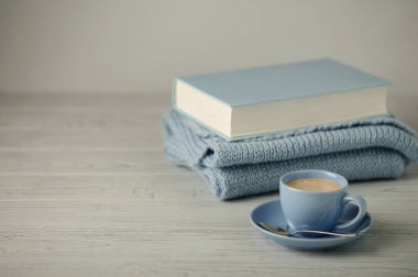 Kahve ışık mavi Kupası ve mavi bağlama ile bir knitt kitapta