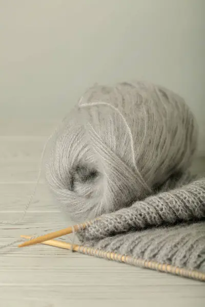 Knitting from woolen threads of gray color.