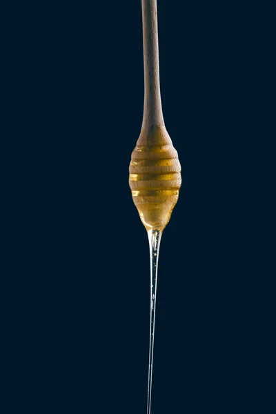 Honey stick on black background — Stock Photo, Image