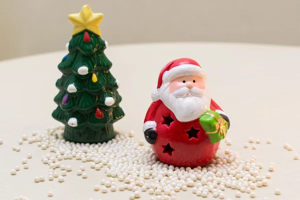 a clay figurines of Santa Claus and Christmas tree