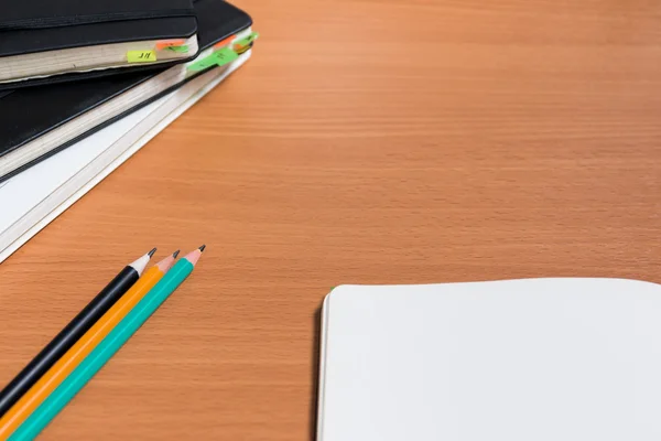 Açık defter ile üç kalem mock-up